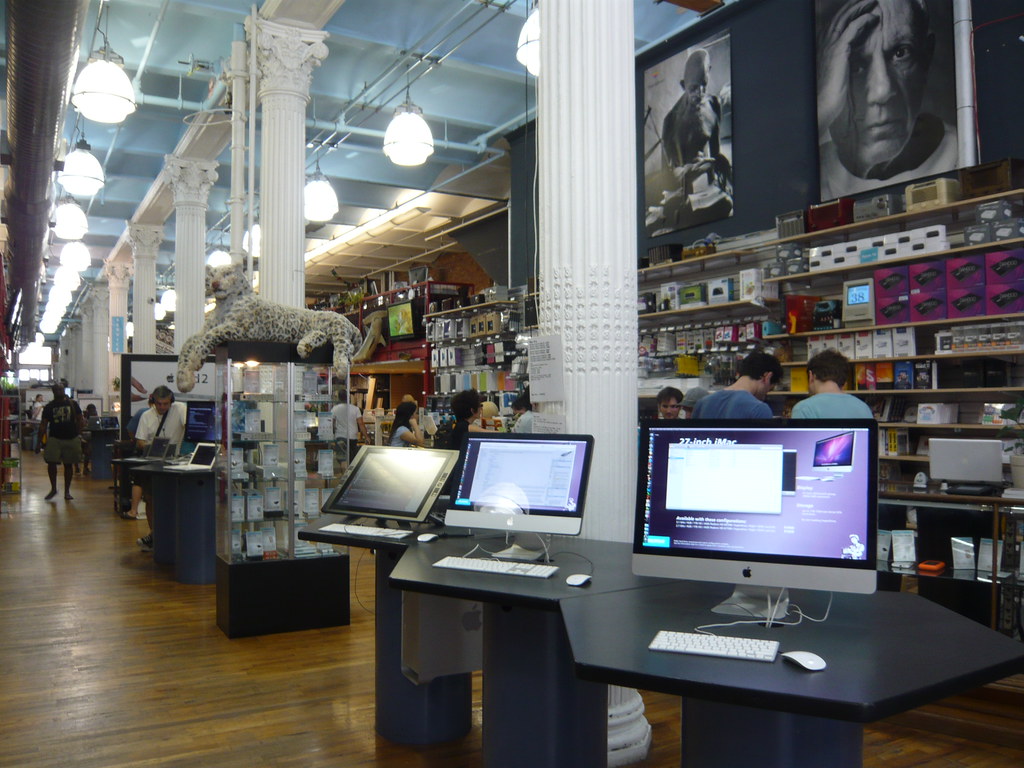 Photo of interior of Tekserve location with iMacas and mac posters